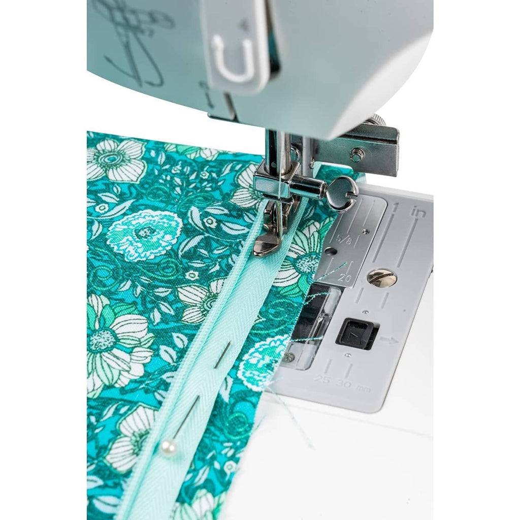 Vertical needle zipper foot stitching along a zipper tape on patterned fabric
