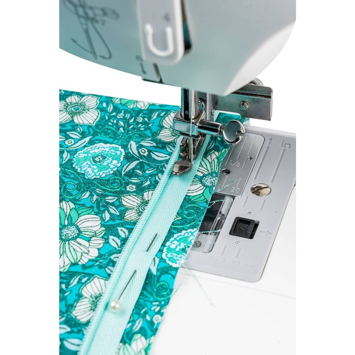Vertical needle zipper foot stitching along a zipper tape on patterned fabric