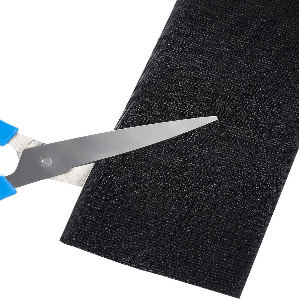 Black cable protector strip being cut to size with scissors, neat trim edge