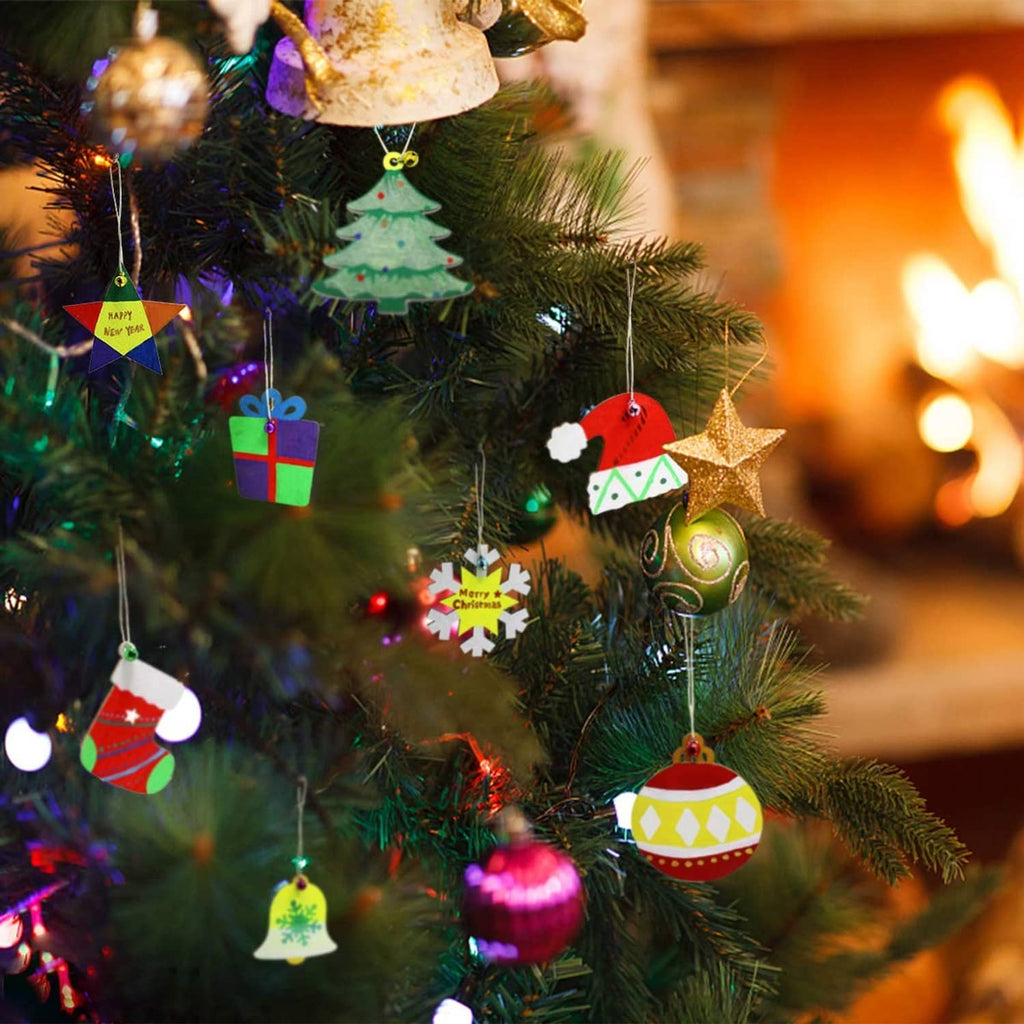 Painted wooden Christmas ornaments hanging on a Christmas tree, red, green, and gold