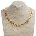 Gold chain necklace with chunky curb links on a beige display bust