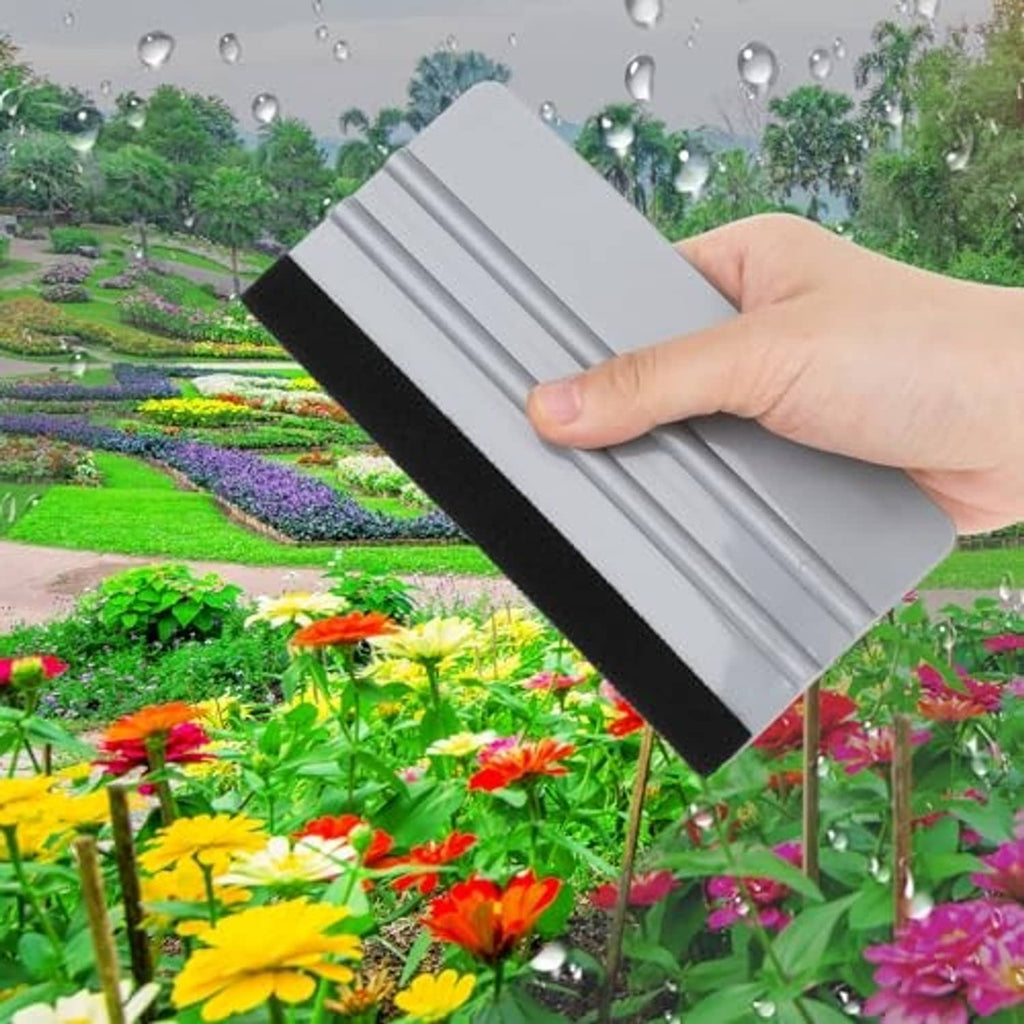 Felt squeegee in hand smoothing window film with a gray ribbed pad