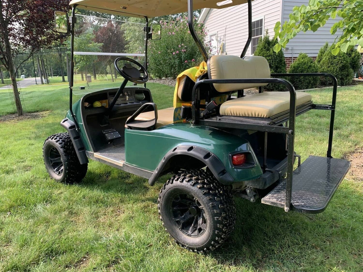 Black front and rear fender flares installed on a green EZGO TXT golf cart