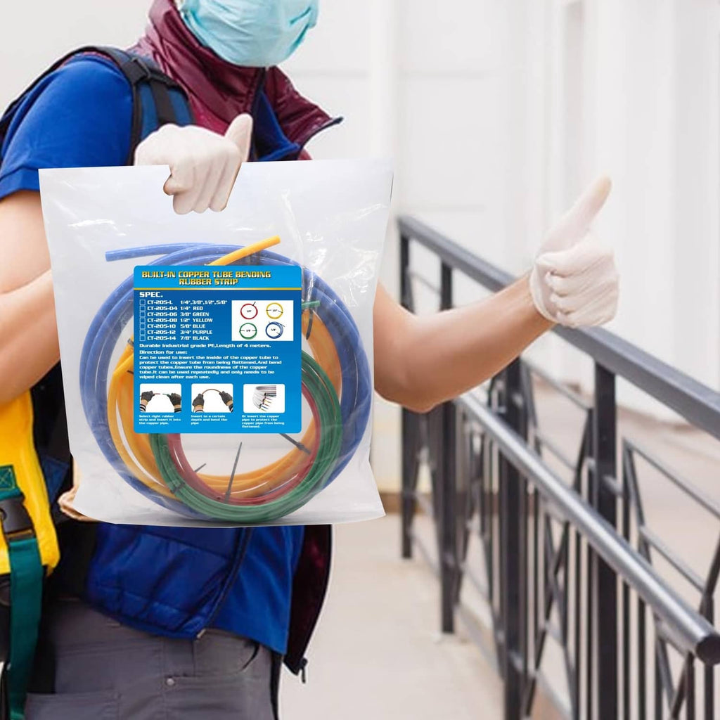 Worker holding a bagged multicolor copper tubing extension set with coiled hoses