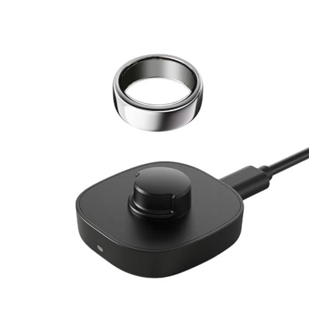 Black Oura Gen3 charging dock with metal ring top and connected cable