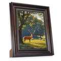 Vintage black picture frame with gold bead trim, holding an 8x10 scenic deer photo.