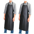 Black waterproof rubber vinyl apron with wide front bib and long skirt, worn over a shirt.