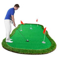 Green artificial golf putting green mat with multiple cup flags and a golf ball
