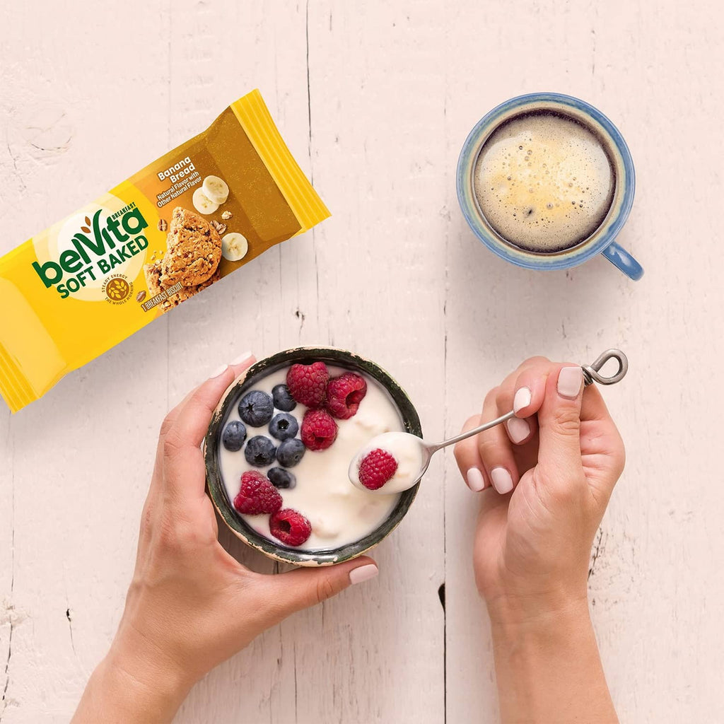 Belvita Soft Baked banana bread biscuit pack next to a bowl of fruit yogurt