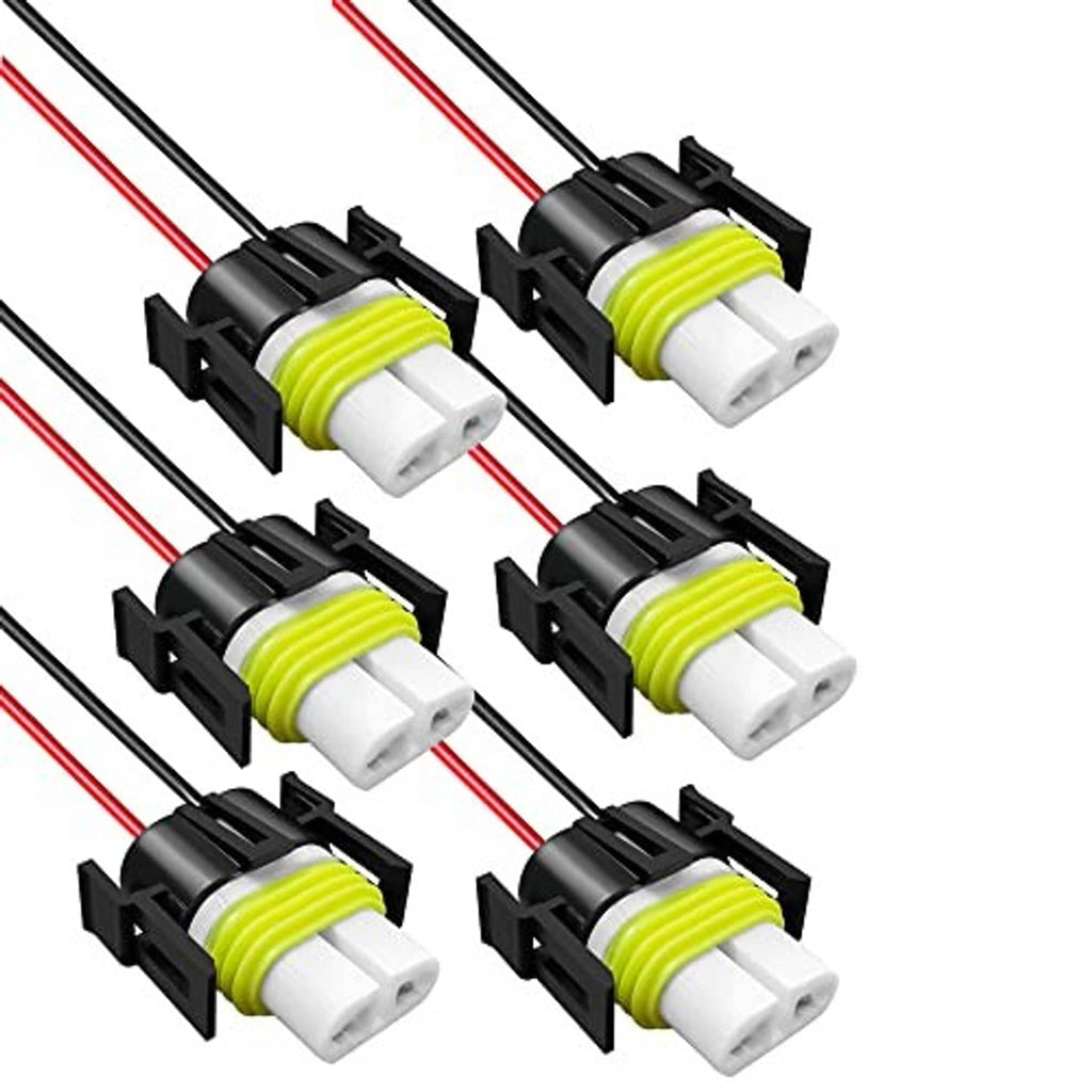 Set of ceramic wire harness socket connectors with black mounts, white plug tips, green insulation sleeve