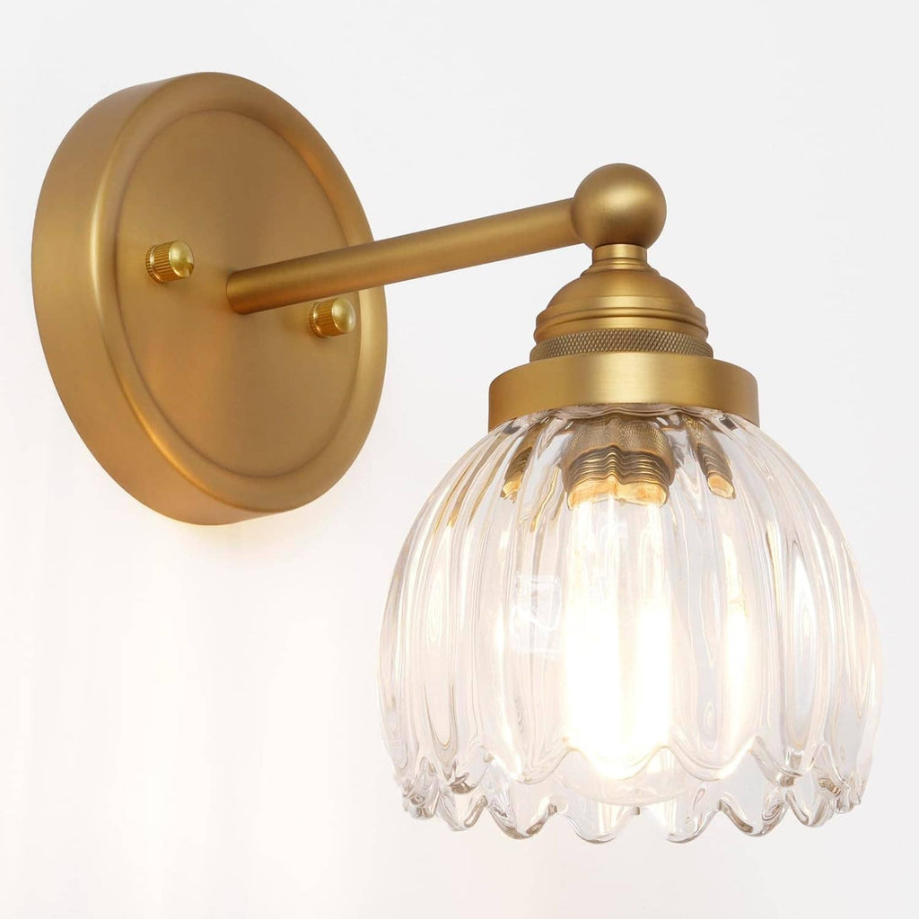 Wall sconce with arched arm, gold dome base, and ribbed glass tulip shade.