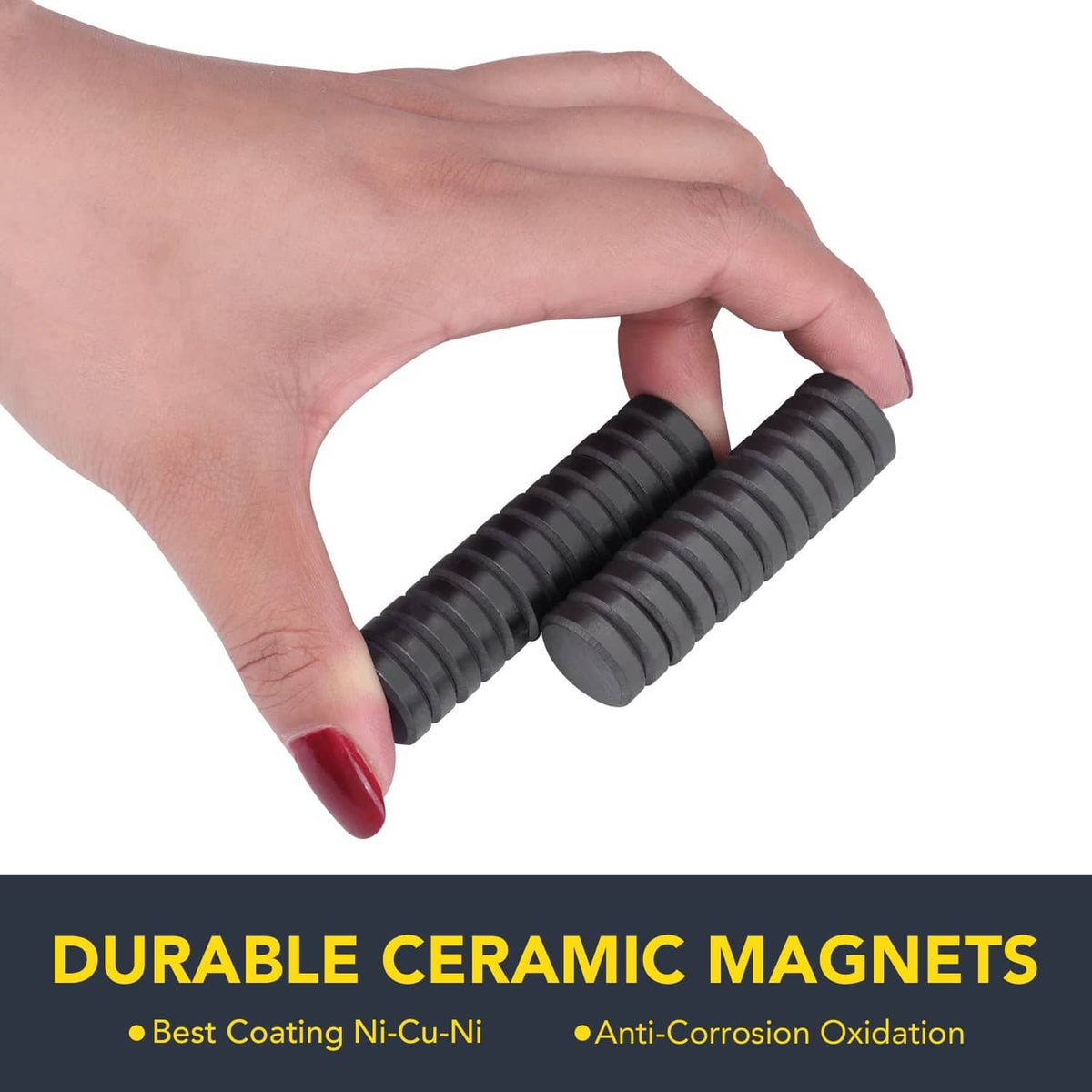 Hand holding a strip of round dark gray ceramic disc magnets