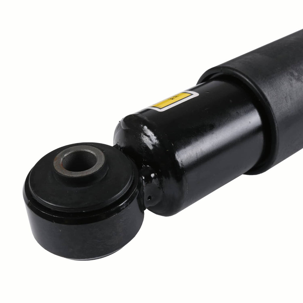 Close-up of black shock absorber lower eyelet mount with bushing and mounting hole