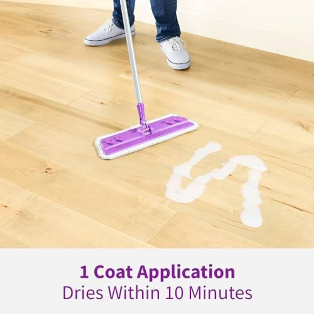 Person mopping a light wood floor with a purple pad and pole handle