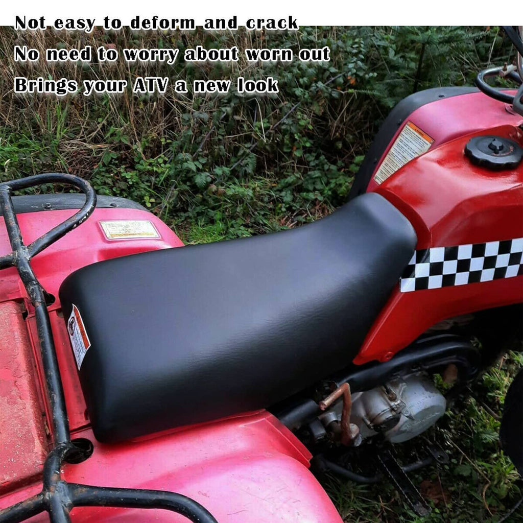Black ATV seat mounted on red ATV, side profile view