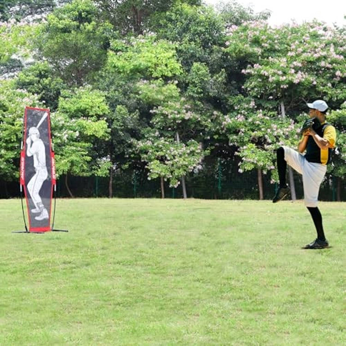 Red pitching target net with batter silhouette, freestanding with stakes in ground