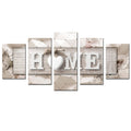 Staggered canvas wall art panels spelling "HOME" with heart, beige gray geometric background