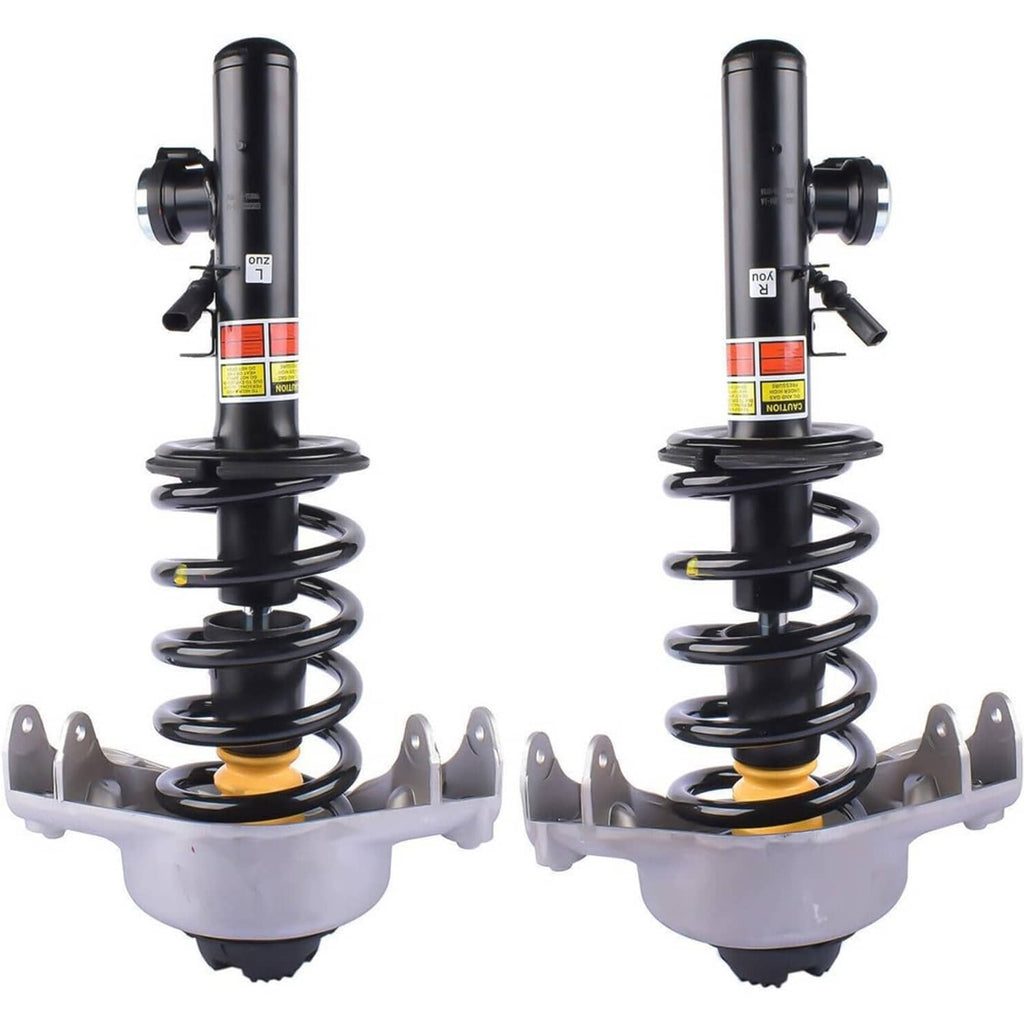 Pair of front shock struts with black cylinders, coil springs, and mounting brackets