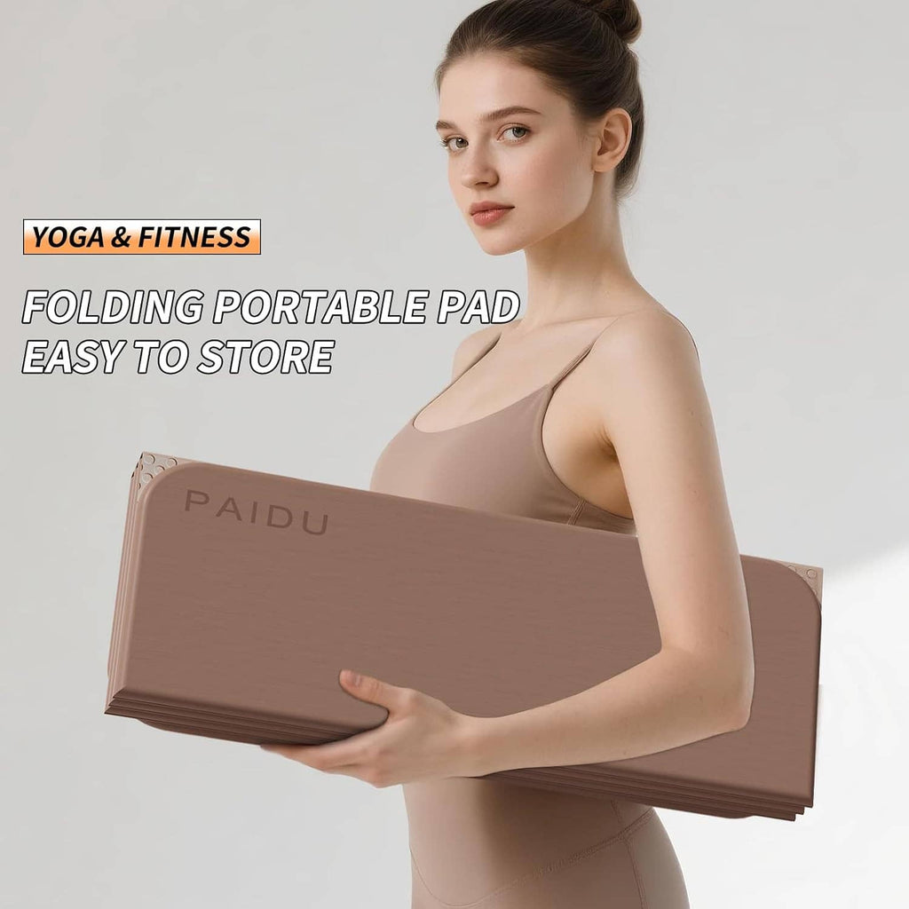 Foldable portable yoga mat held upright, taupe/brown TPE surface