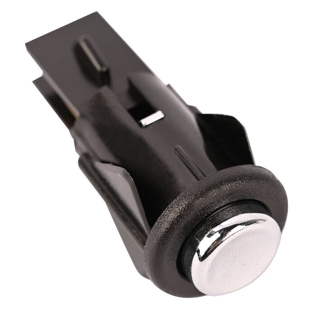 Fuel door release switch with chrome button and black mounting tabs, close-up