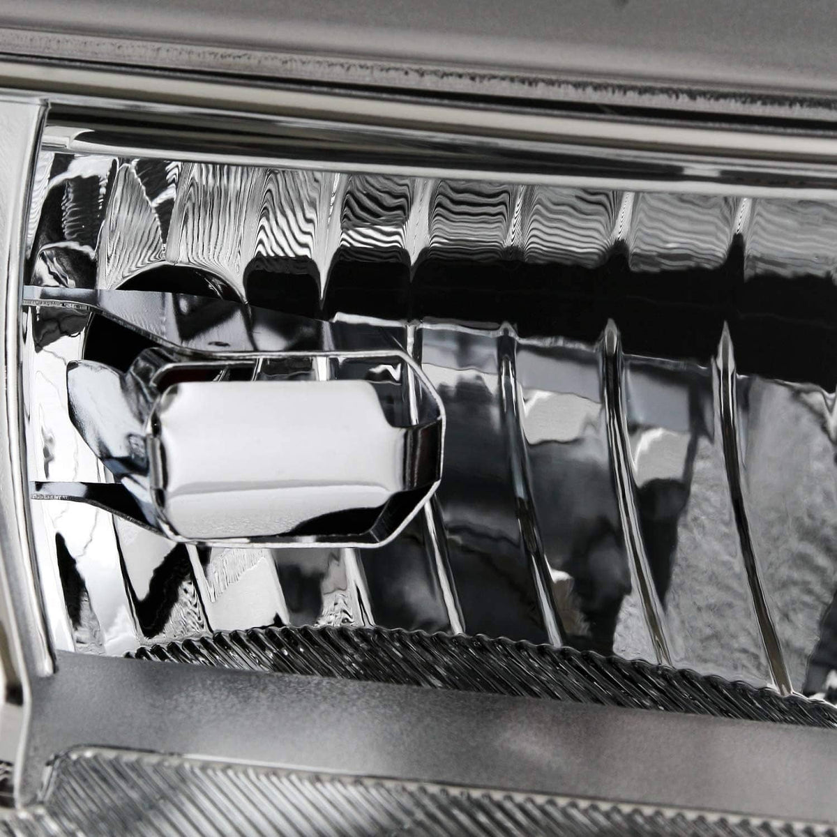 Close-up of chrome reflector housing inside the headlight