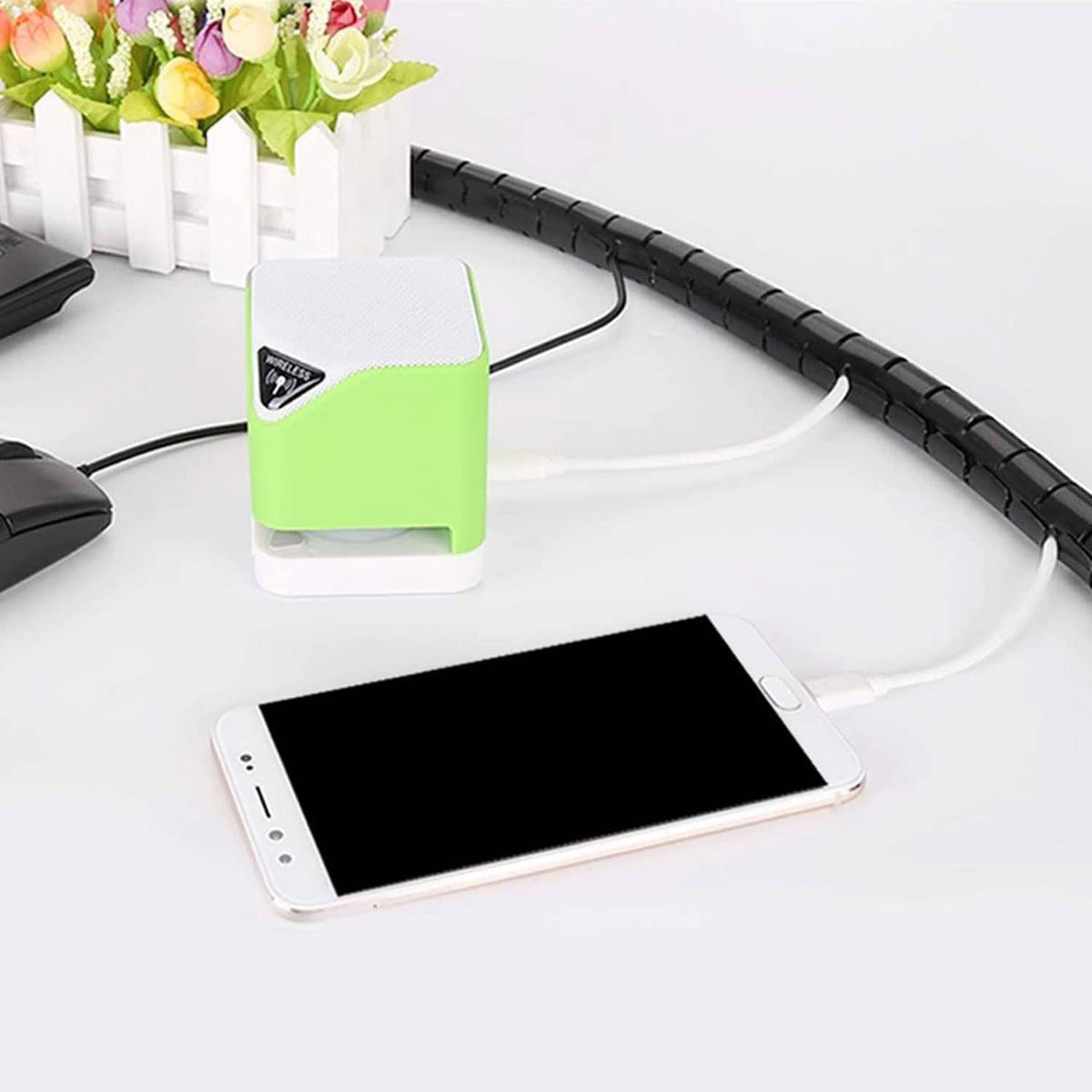 Black spiral cable wrap routing charging cables to a compact power adapter