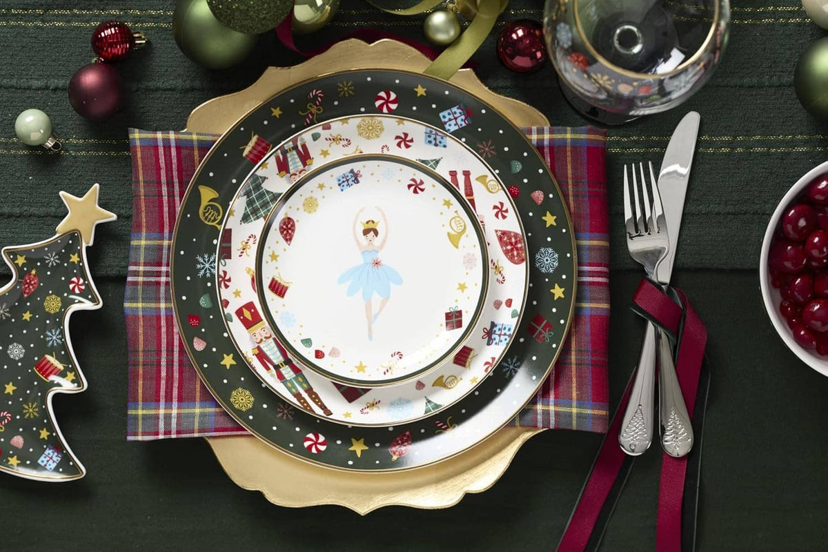 Porcelain dinner plate with dark Christmas border and ballerina nutcracker-style centerpiece