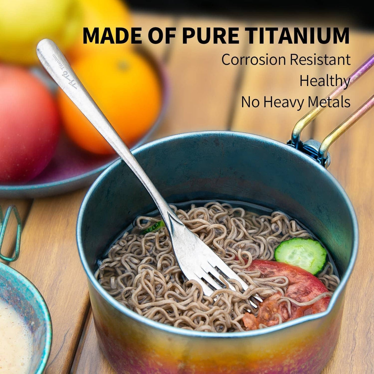 Silver titanium spoon and fork in a bowl of noodles