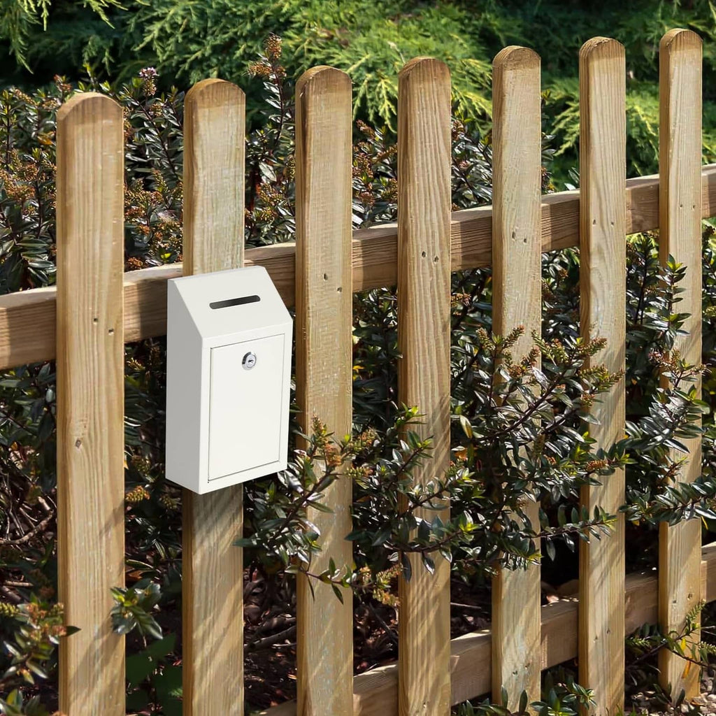 White metal cash drop box mounted on wooden fence with front lock and deposit slot