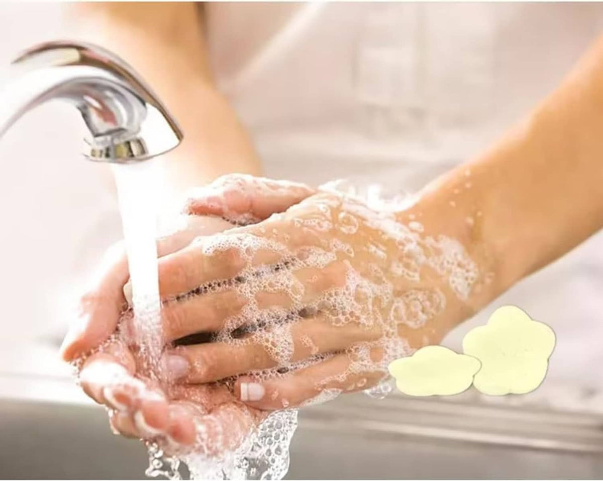 Petal soap paper used while washing hands under a faucet, foam and sheets visible