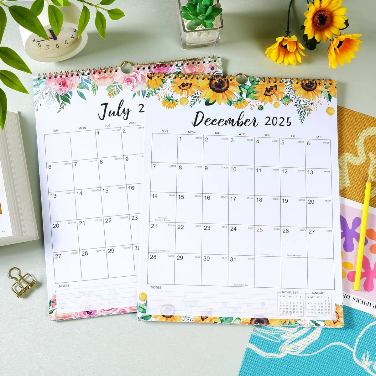 Two floral monthly wall calendars with spiral binding, showing July 2025 and December 2025