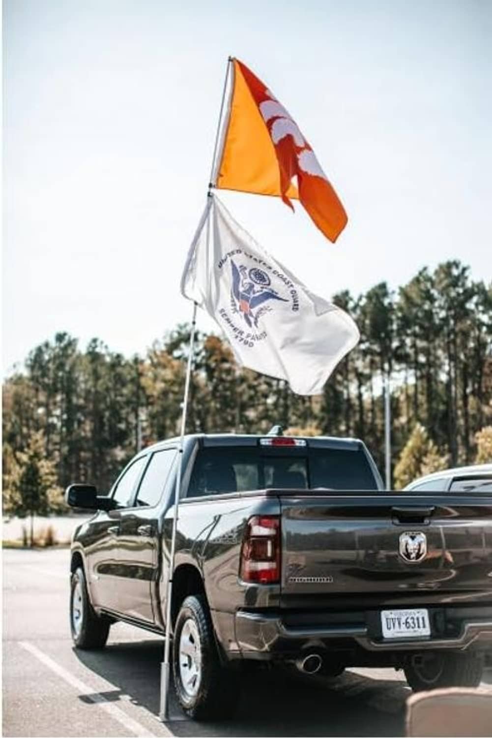 Portable flagpole with tire mount on pickup truck, orange and white flag