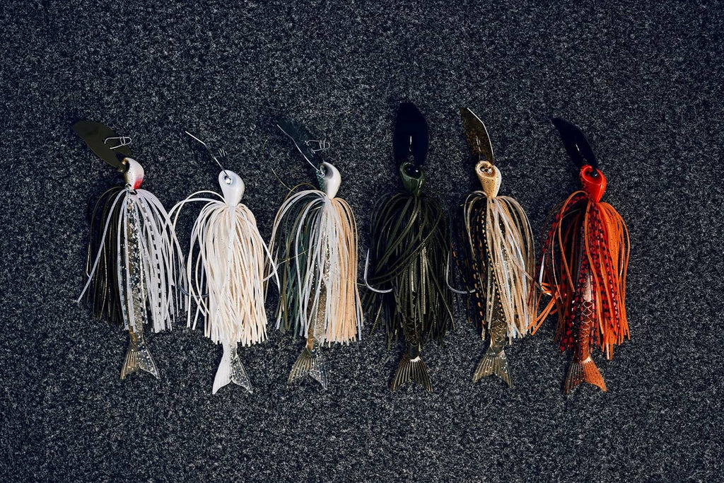 Assorted bladed fishing jigs with hooks, blades, and varying skirt colors