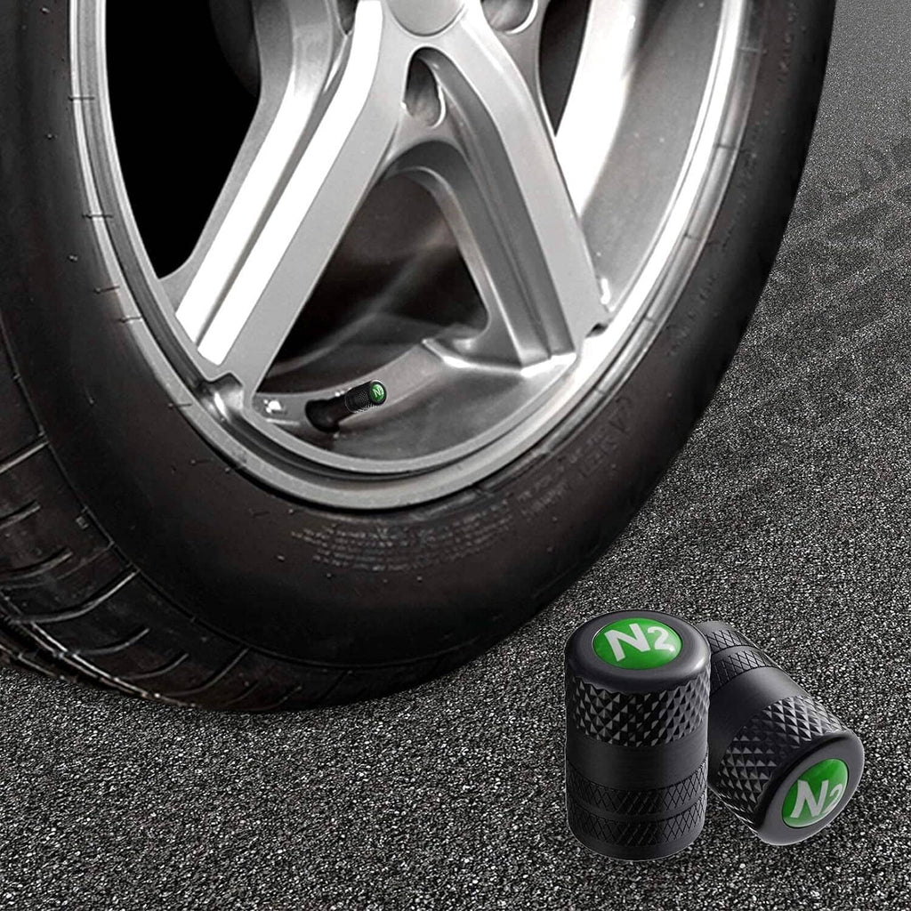 Set of black tire valve stem caps with green N2 logo and textured surface
