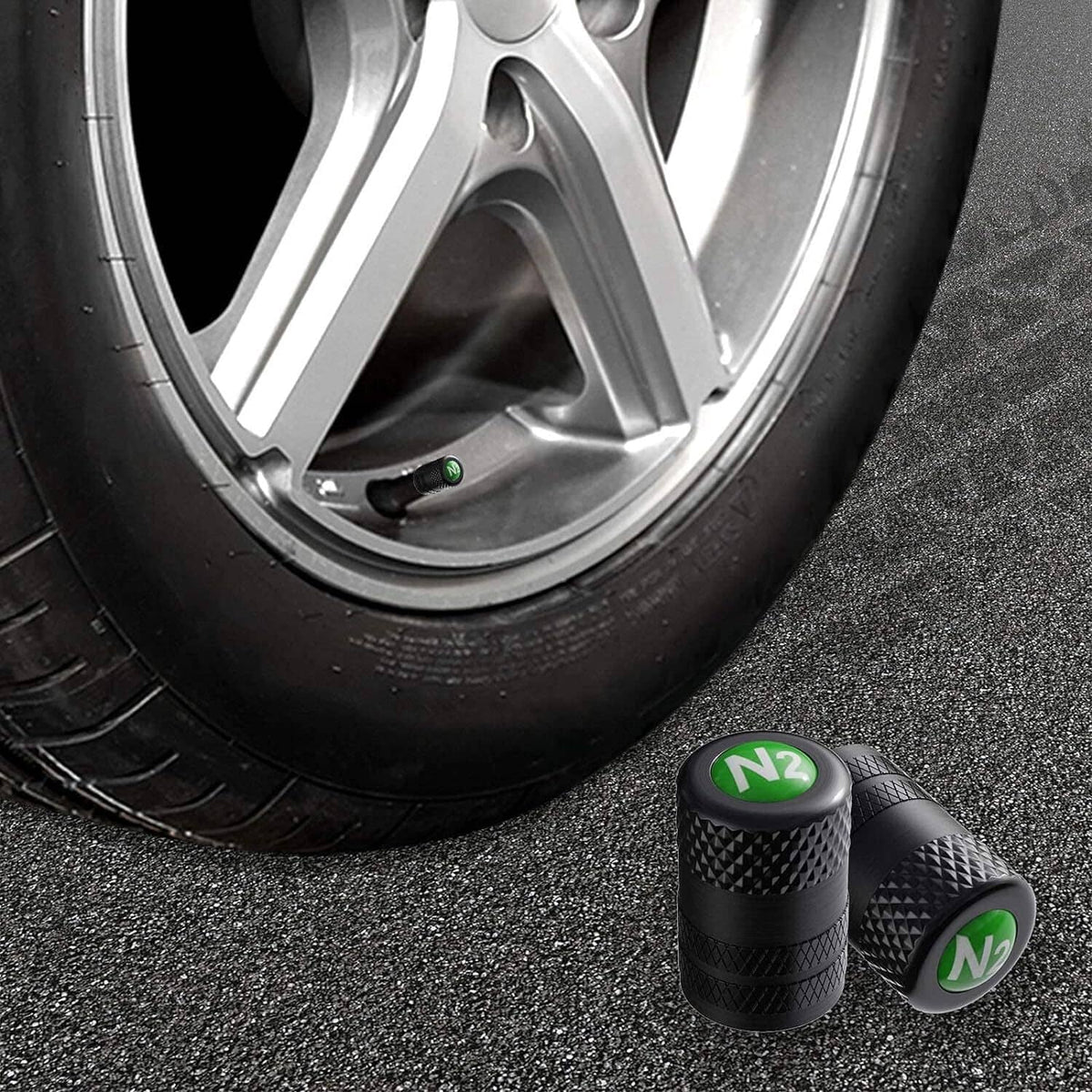 Set of black tire valve stem caps with green N2 logo and textured surface