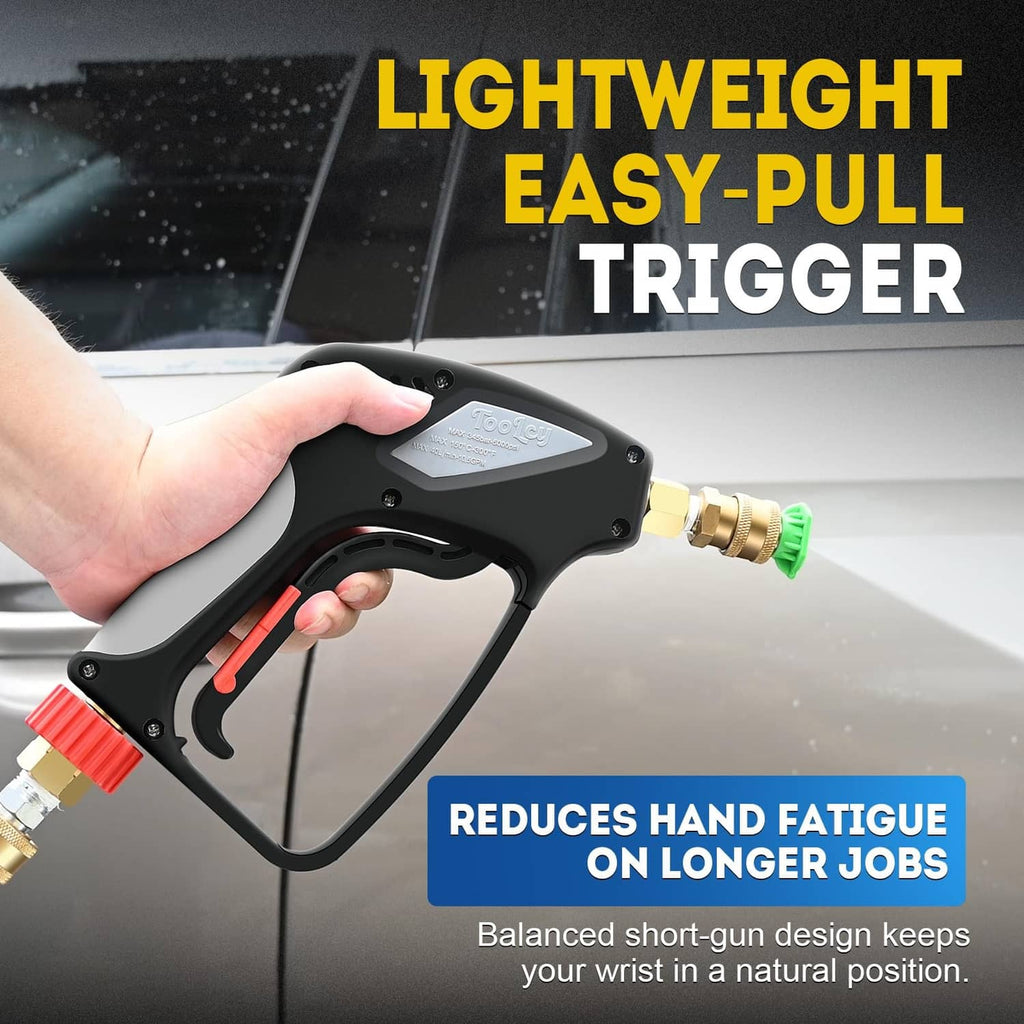 Black pressure washer gun with ergonomic trigger and brass fitting, held in hand