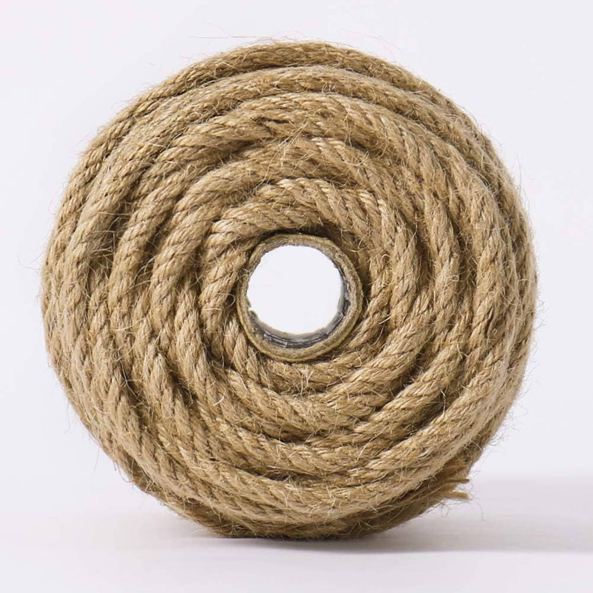 Twisted jute rope coil in natural tan, neatly looped with rope center hole visible.