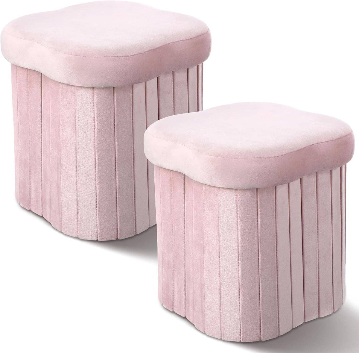 Two pink velvet storage ottomans with cushioned round lids and vertical ribbed sides