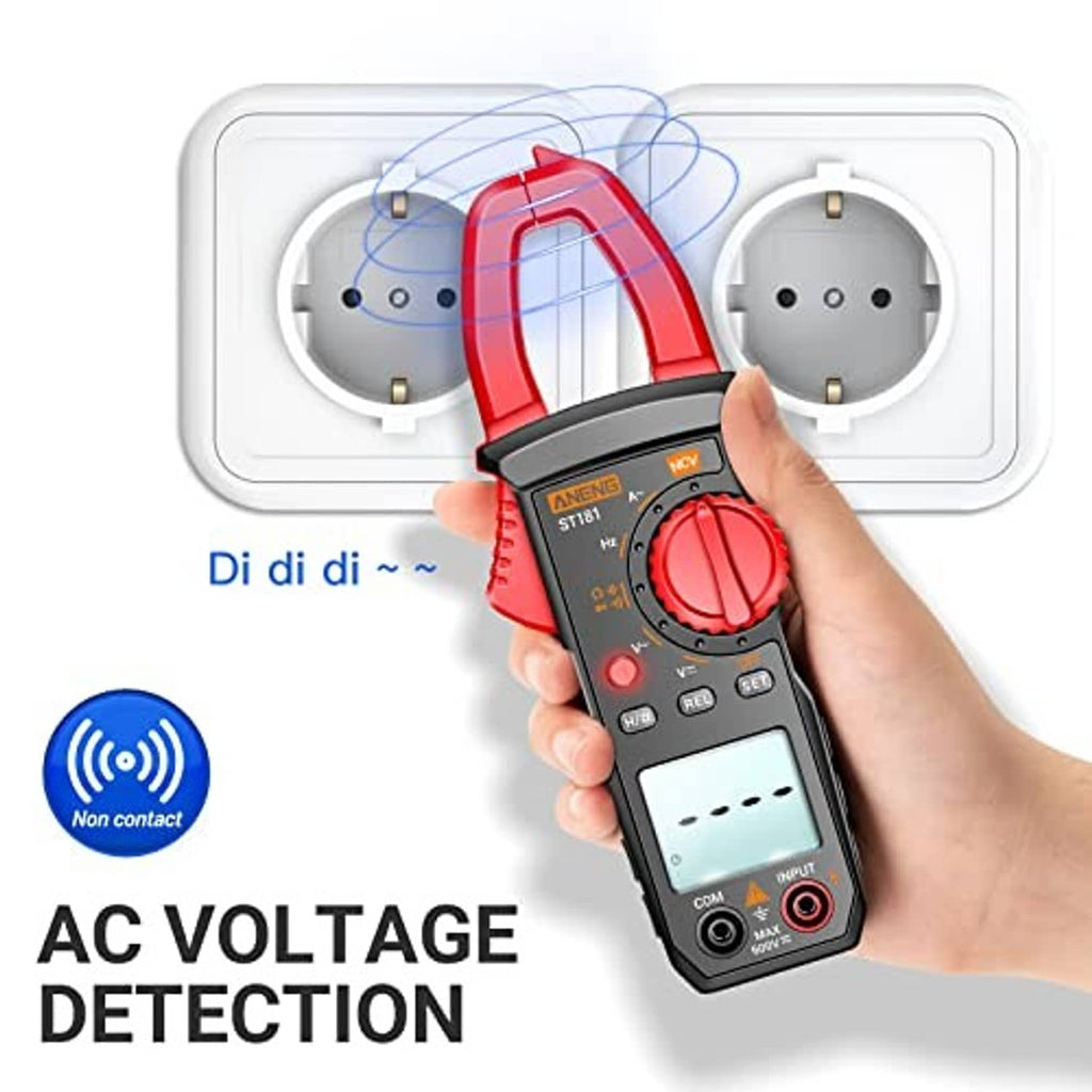 Hand holding red clamp meter for AC voltage detection near wall outlet