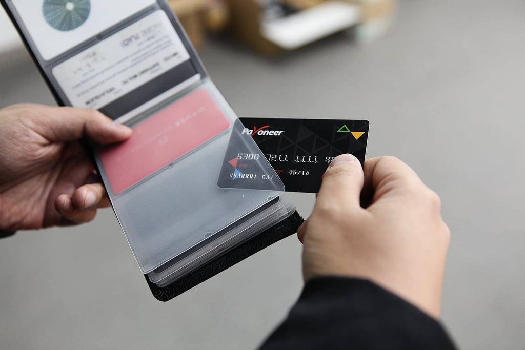 Ai-dee RFID-blocking leather wallet being accessed with cards in hand