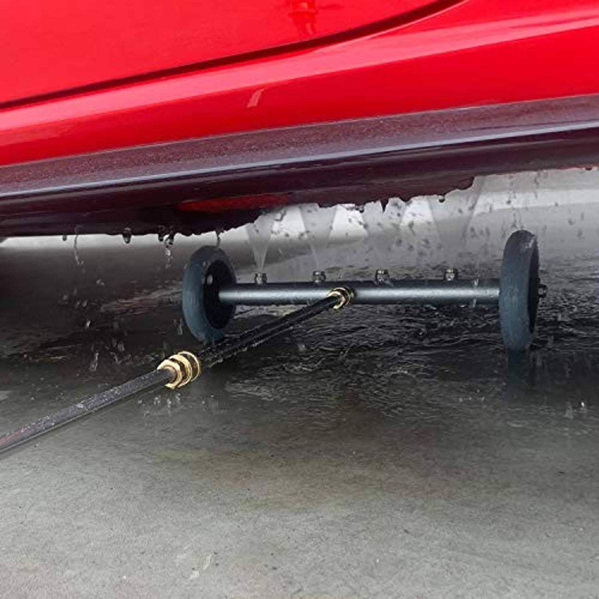 Undercarriage pressure washer cleaner spraying under vehicle using wheeled wand