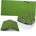 Green artificial grass putting mat, folded corner with visible turf pile texture