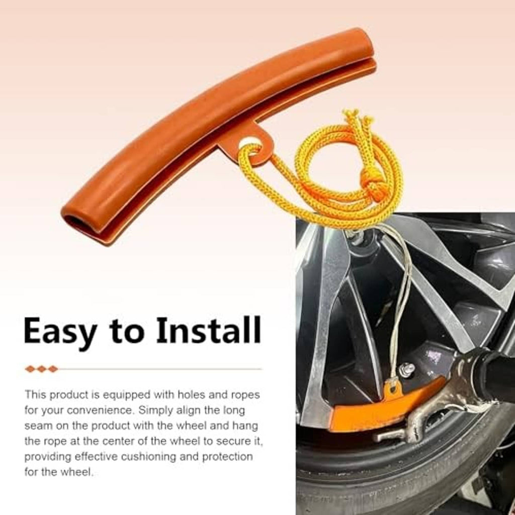 Orange curved rim protector with yellow rope attached near the wheel