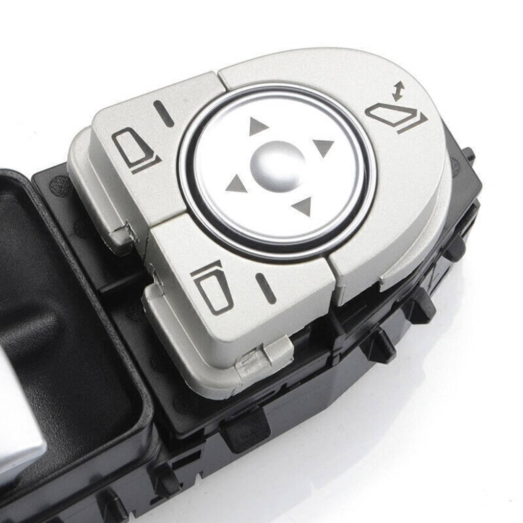 Power window master control switch close-up with silver directional button ring