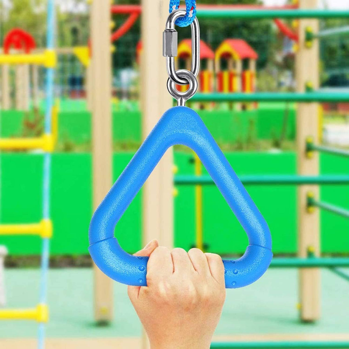 Blue trapeze swing bar ring with metal carabiner above a hand on a playground