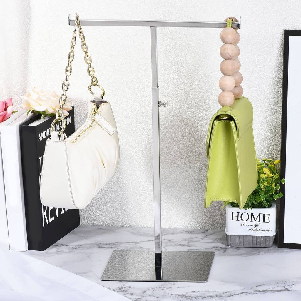 T-shaped metal purse display rack with flat base and top horizontal bar, silver