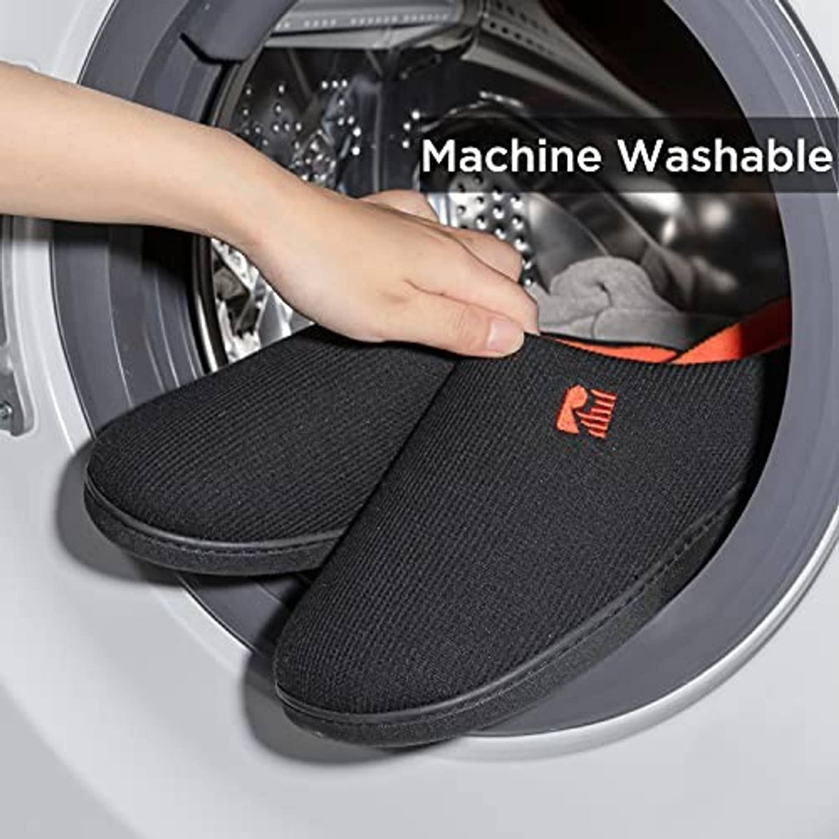 Black two-tone slip-on slippers with orange lining placed in a washing machine