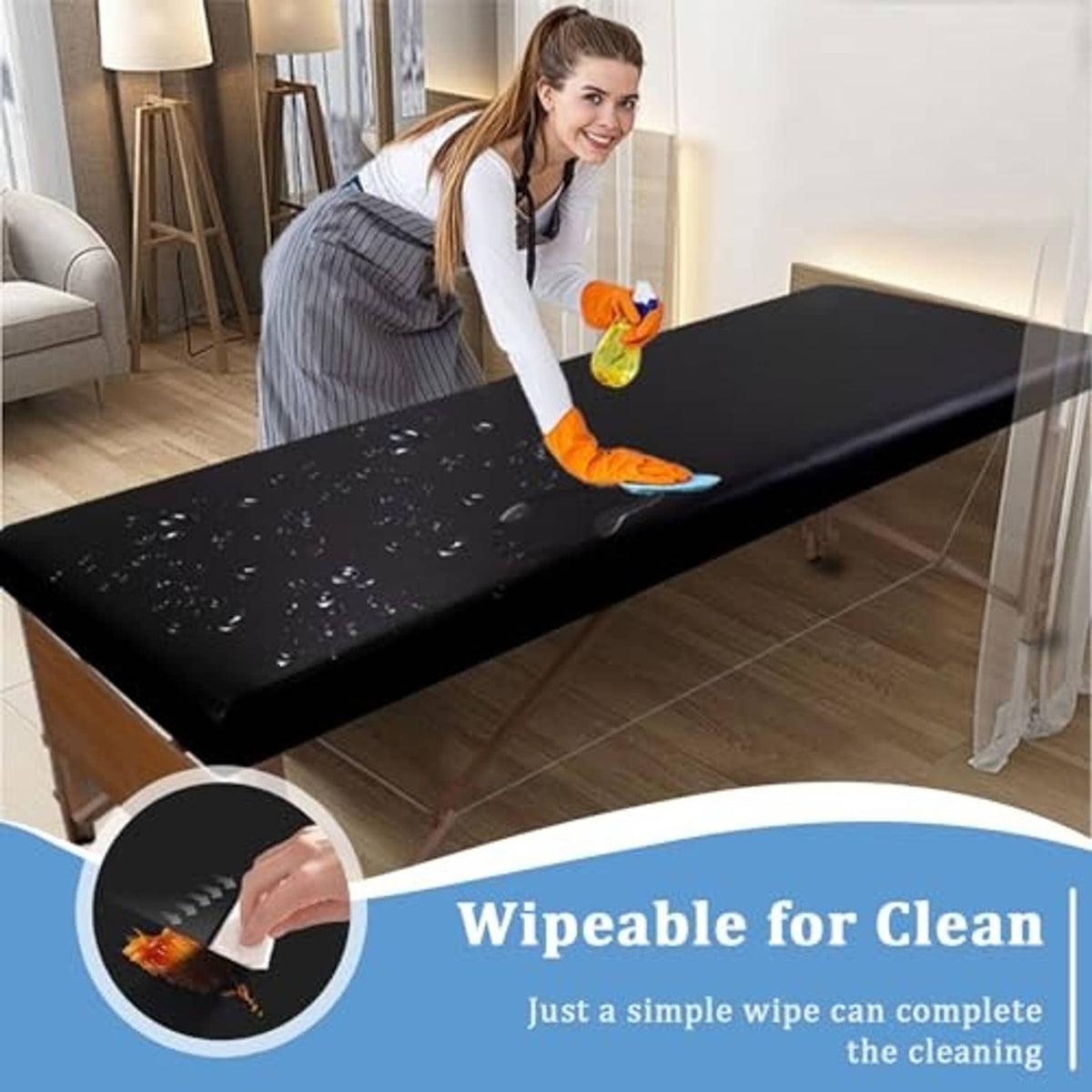 Black wipeable leather massage table cover being cleaned with a cloth