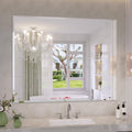 Frameless rectangular bathroom mirror with beveled edges, wall-mounted above bathtub