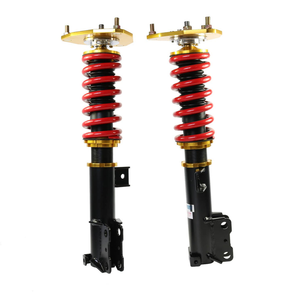 Two adjustable coilover struts showing red springs, black shocks, gold top mounts